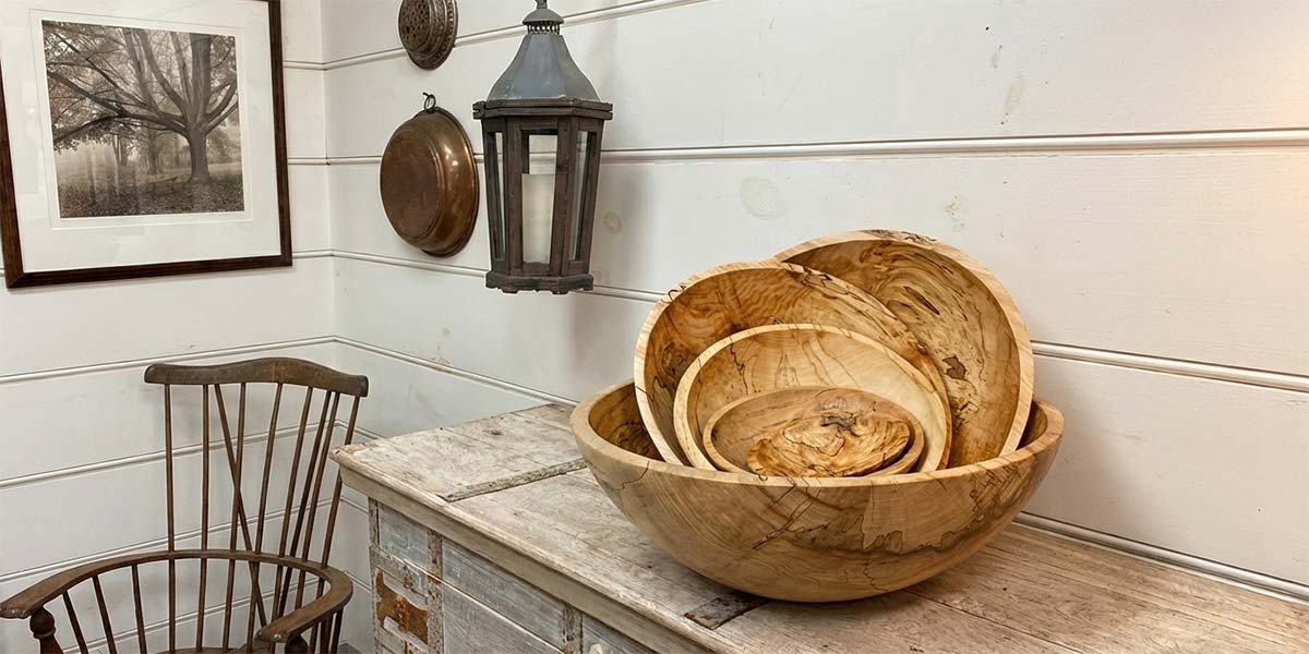 Set of nested ambrosia maple bowls highlighting natural grain and beetle marks