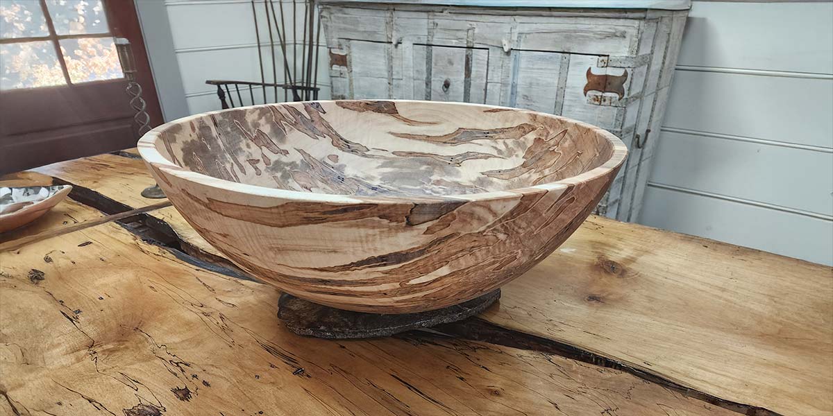 Large ambrosia maple serving bowl showing flowing grain and natural color shifts