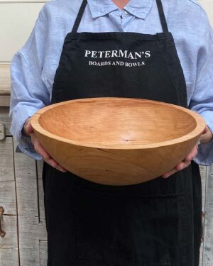 Medium 13-inch cherry round wooden bowl, classic style with warm cherry tones and fine grain.