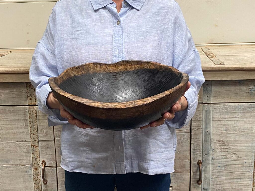 Medium 13-inch ebonized oak oval, live edge wooden bowl, bold dark finish with handcrafted oval form.