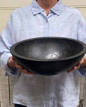 Medium 13-inch ebonized oak round wooden bowl, smooth dark finish highlighting oak grain.