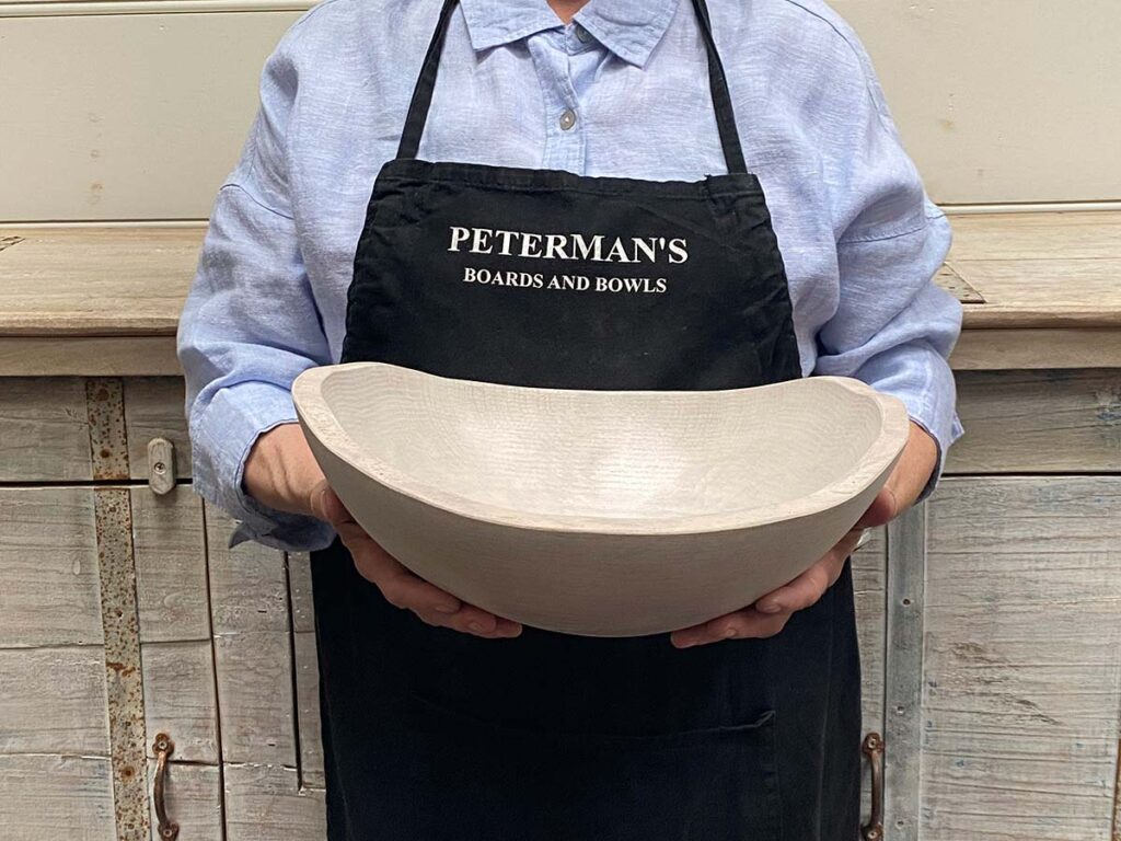 Medium 13-inch white pearl oak oval, live edge wooden bowl, light-toned artisan-crafted bowl with live edge.