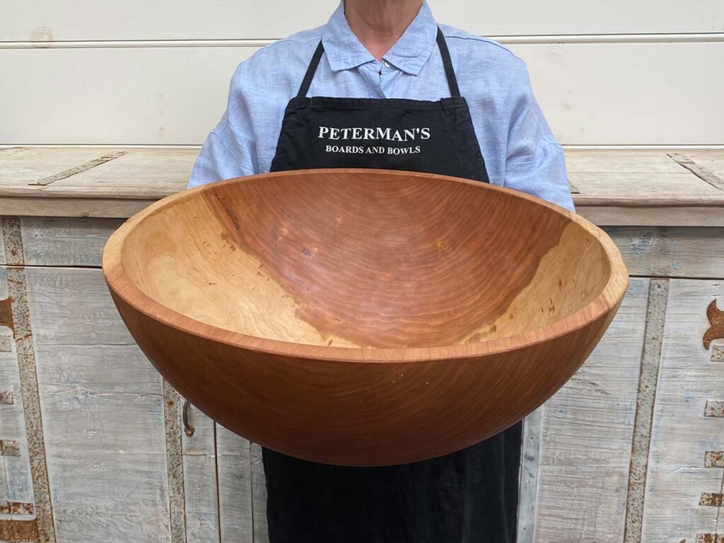 XXL jumbo 21-inch round Cherry wooden bowl, hand-turned, food-safe, perfect for salads or centerpiece serving.