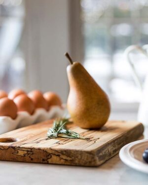 Handmade wooden cutting board displayed on a kitchen breakfast table