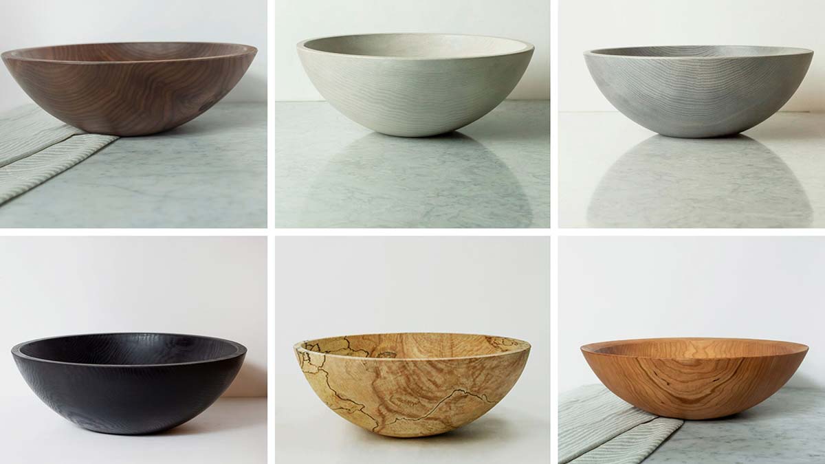 Collection of wooden serving bowls in different woods and finishes, shown as an example of reusable wooden bowls compared to plastic options.