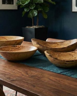 Four spalted maple wooden bowls displayed on a dining table, two 13-inch bowls paired with two 10-inch bowls on a blue linen runner