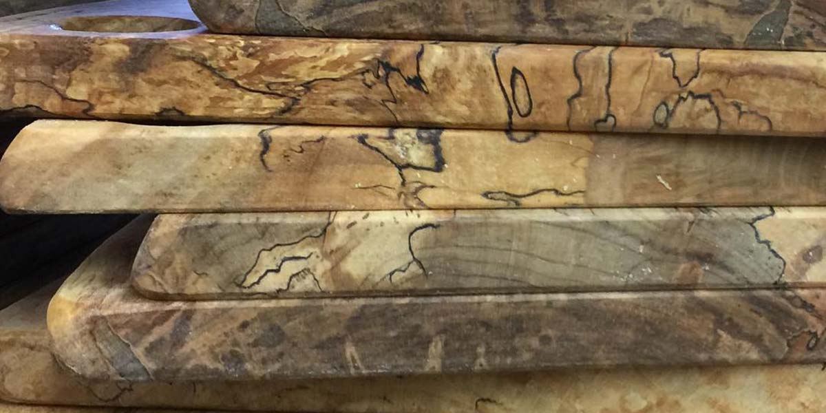 Close-up of stacked wooden boards showing natural grain and markings