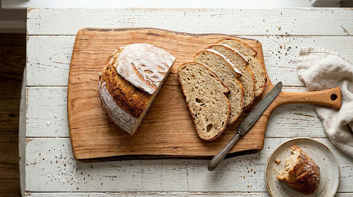 Extra large live edge cherry cutting board is the perfect size to use as a bread board