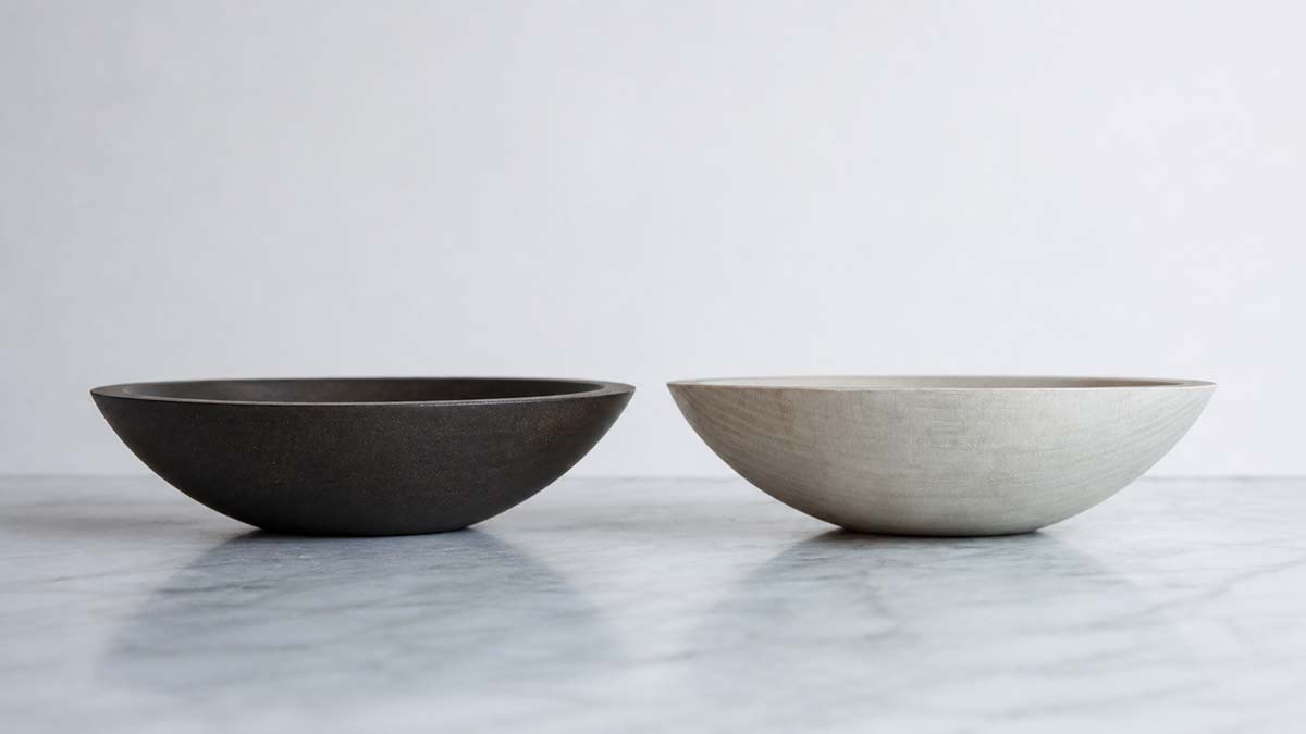 Heirloom gifts for mom featuring two hand-turned wooden bowls in black ebonized and white pearl natural finishes on a marble surface